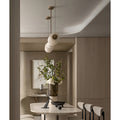 Side view of marble linear chandelier with warm diffused LED light