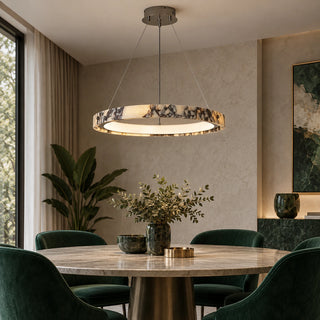 Marmielle marble pendant above a dining table with green chairs