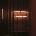 Milano Halo Ring Pendant Light in double-ring configuration with warm ambient glow against a dark wood backdrop