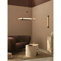 Single-ring Milano Halo Ring Pendant Light styled in a modern lounge with warm ambient lighting