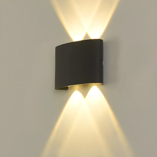Illuminated 4-beam minimalist black LED wall light mounted on a neutral wall, casting symmetrical upward and downward beams