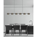 Minimalist linear chandelier installed above a modern dining table with black chairs