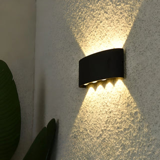 Close-up of LED wall lamp installed on textured wall surface