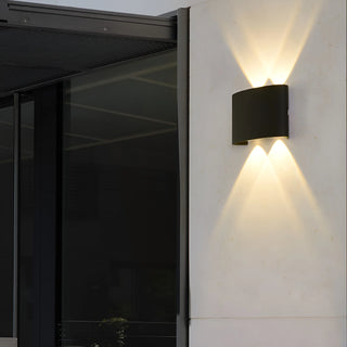 LED wall lamp mounted outside, casting warm light in the evening