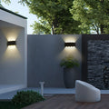 Outdoor LED wall lamps illuminating a modern garden wall