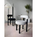 Contrast black and white minimalist chairs styled in a contemporary interior