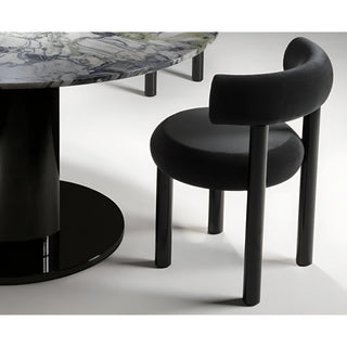 Side view close-up of a minimalist upholstered chair with circular seat