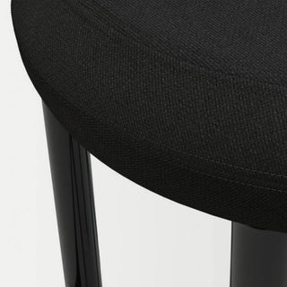 Close-up texture and stitching detail of the seat on a minimalist upholstered chair