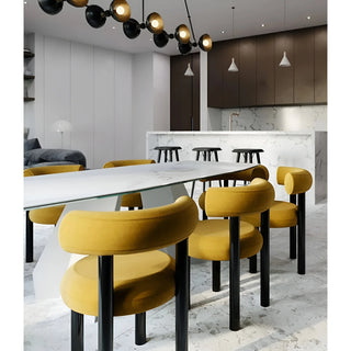 Minimalist upholstered chair in yellow placed around a modern dining table