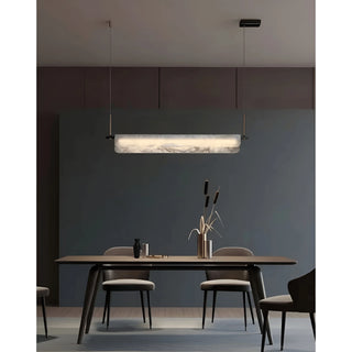 Elegant MIRODEMI marble pendant light with linear brass details, illuminating a refined dining space in a warm, modern atmosphere