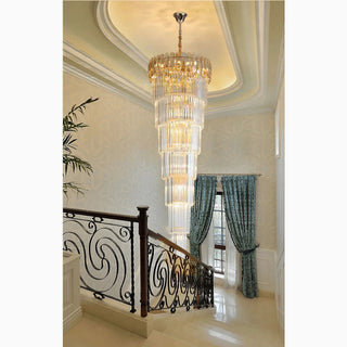 Long crystal chandelier cascading down a stairwell