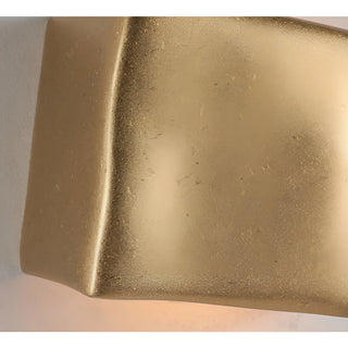 Close-up of a gold metallic surface with a textured finish.