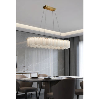Mirodemi Cloudstone chandelier in marble and copper suspended over a modern dining table