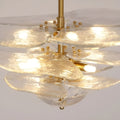 Close-up of the Mirodemi Lunaria layered clear glass disc chandelier with brass hardware and warm glowing bulbs
