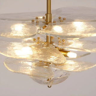 Close-up of the Mirodemi Lunaria layered clear glass disc chandelier with brass hardware and warm glowing bulbs