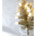 Close-up detail of the Mirodemi Lunaria layered clear glass disc chandelier with polished brass hardware