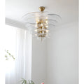 Mirodemi Lunaria layered clear glass disc chandelier with brass hardware in a bright white room