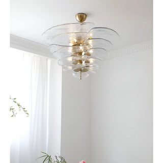 Mirodemi Lunaria layered clear glass disc chandelier with brass hardware in a bright white room