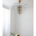 Mirodemi Lunaria layered clear glass disc chandelier with brushed brass hardware in an airy white interior