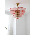 Mirodemi Lunaria layered glass disc chandelier in pink glass with brass hardware in a bright white room