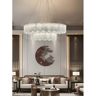 Cloudstone Marble chandelier hanging above a contemporary living room sofa – modern interior lighting
