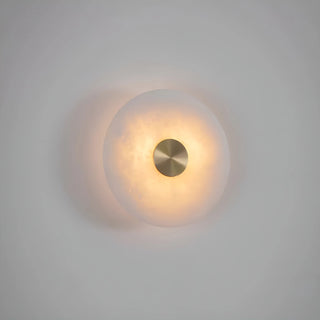 Single MIRODEMI round alabaster wall sconce softly glowing against a neutral background, showcasing its stone translucency