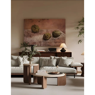 MIRODEMI travertine round tables styled in a warm modern living room with soft lighting, art wall, and neutral sofa decor