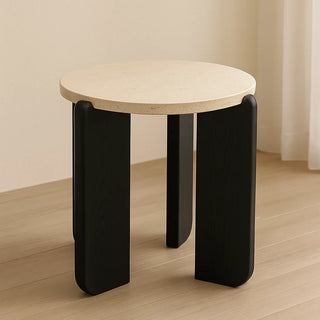 MIRODEMI travertine round side table with cream stone top and black solid wood legs, photographed in a minimalist interior