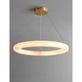 Modern alabaster chandelier glowing warmly, showcasing natural stone translucency and brass details