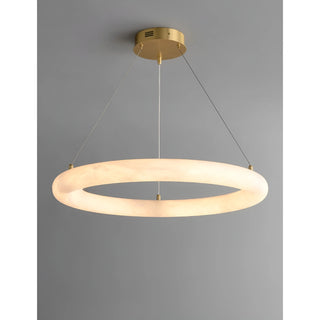 Modern alabaster chandelier glowing warmly, showcasing natural stone translucency and brass details