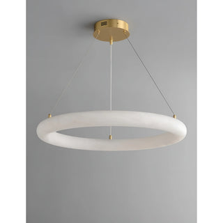 Modern alabaster ring chandelier with brass frame turned off, showing clean sculptural design