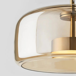 Detailed close-up of Nordic amber glass pendant lamp with soft golden finish and minimalist design