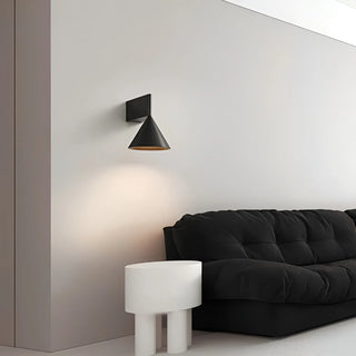 Modern bedroom with black Bauhaus wall lamp above sofa - minimalist lighting accent by Mirodemi