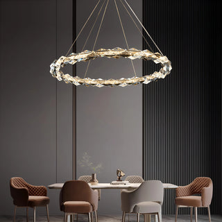 Modern K9 crystal ring chandelier hanging above a contemporary dining table setup