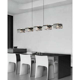 Modern five-light linear chandelier with textured glass shades in a white contemporary dining space