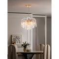 Contemporary dining room styled with a sculptural Murano glass chandelier and brass accents