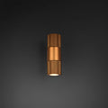 Gold LED industrial wall sconce glowing on dark background