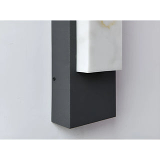 Detail of matte black base on the modern marble-look LED wall sconce, showcasing sleek texture and form