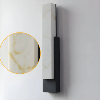 lose-up of the unlit faux marble LED sconce in matte black finish showing detailed material texture