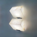 Modern marble wall sconce with two stacked geometric shades and soft ambient light