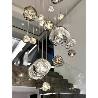 Large cascading chandelier featuring clear and smoky glass globes, ideal for modern staircases or high ceilings