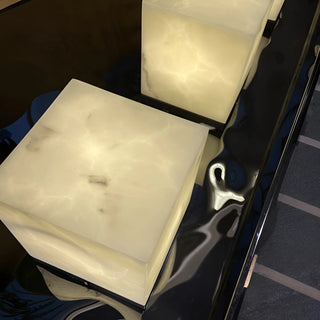 Modern outdoor cube lamp with marble-effect finish, emitting warm ambient glow - Mirodemi luxury garden lighting