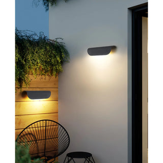 Pair of black Modern Outdoor Wall Lights installed in a cozy patio space with warm ambiance lighting