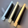 Three modern outdoor wall lights showing different LED color temperatures — cool white, neutral white, and warm white lighting options