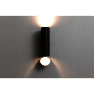 DAWN Series outdoor wall light in black finish lit up, showing both upward and downward illumination