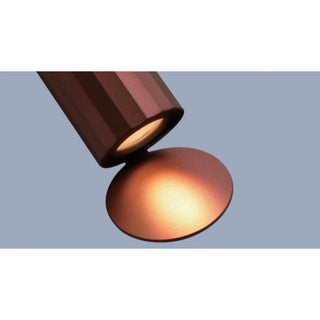 DAWN Series outdoor wall light in bronze finish showing warm glow and reflection disc