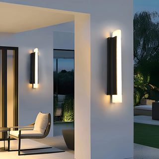 Modern outdoor waterproof wall light mounted on a patio entrance wall at night with warm LED glow