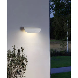 White Modern Outdoor Wall Light installed on the exterior of a building, casting light across the wall