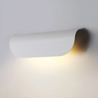 White Modern Outdoor Wall Light emitting a soft warm glow while mounted on an exterior wall