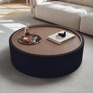 Black round coffee table with walnut veneer top and smooth matte fabric base
